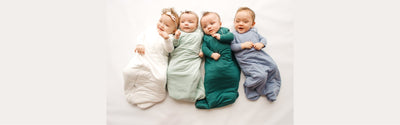 4 babies wearing sleep sacks