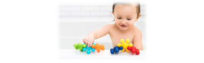 baby playing with toys while in bathtub