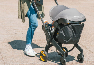 woman pushing baby stroller in Atlanta park
